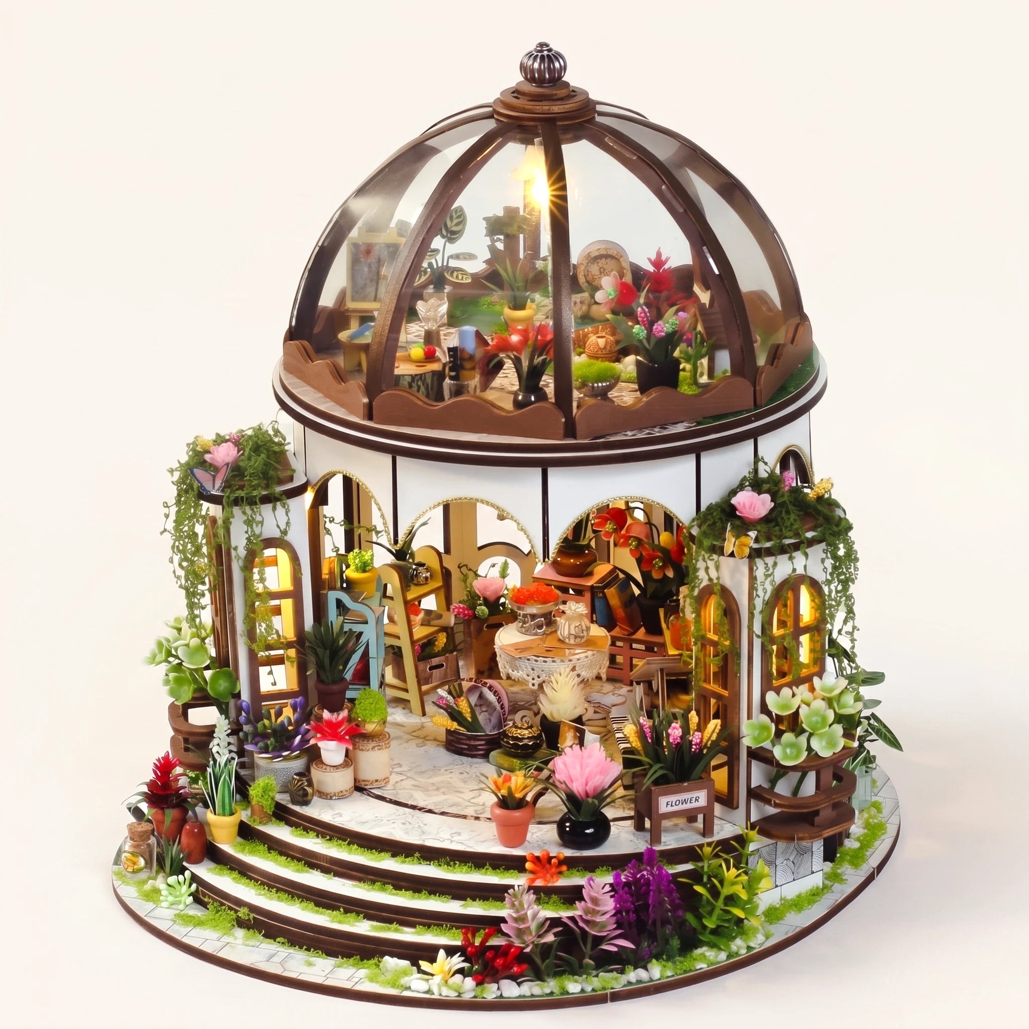 The Bloom Rotunda DIY miniature conservatory kit with LED lights on, pale blush studio hero