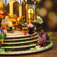 Macro of the curved garden steps and potted blooms of The Bloom Rotunda