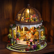The Bloom Rotunda glowing on a dark walnut shelf at night