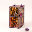 The Butterfly Archive book nook kit on a pale blush studio background with LED lights on