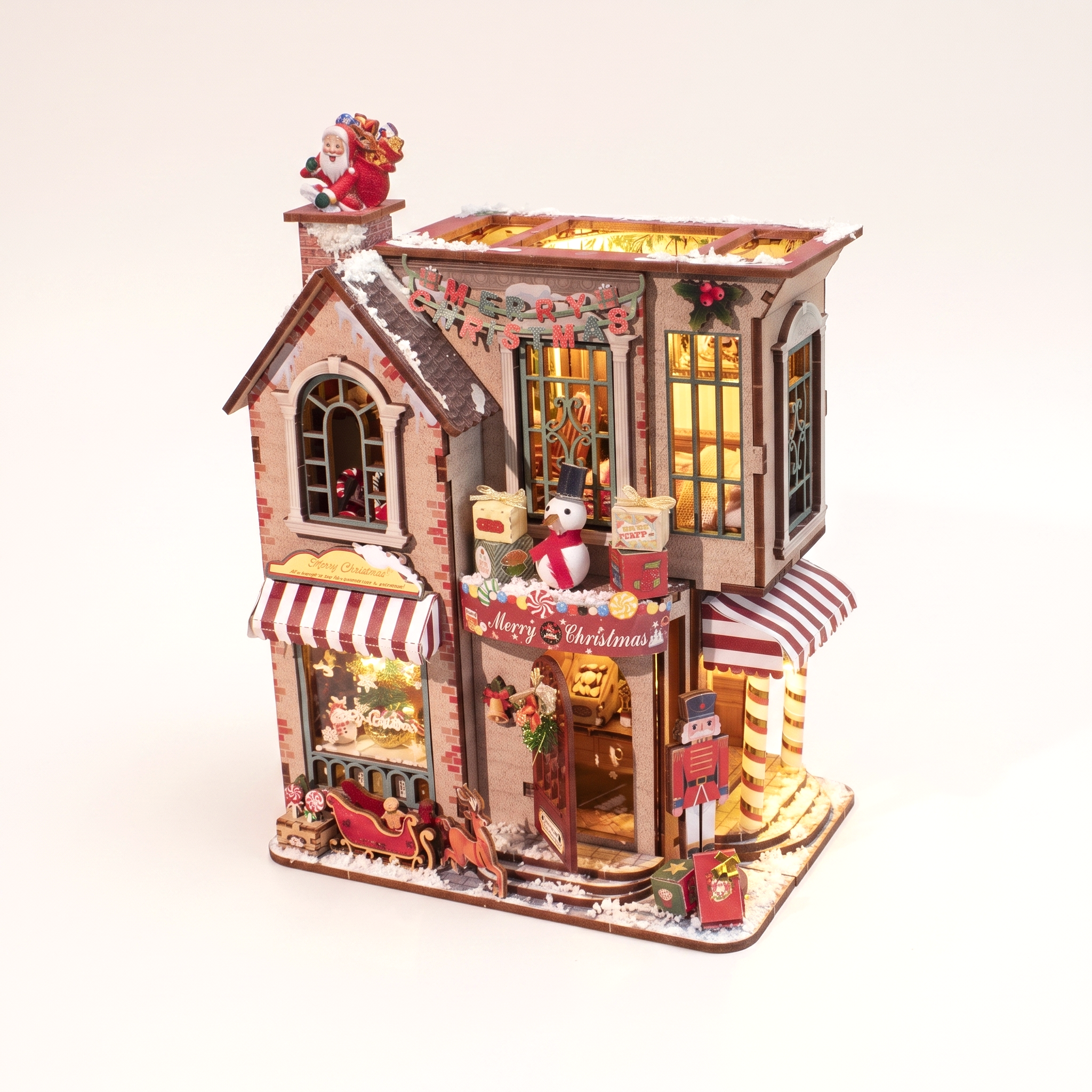 The Candy Cane Cottage DIY miniature kit with LED lights on a pale blush studio background