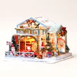 The Christmas Eve Lodge DIY miniature kit on a pale blush background