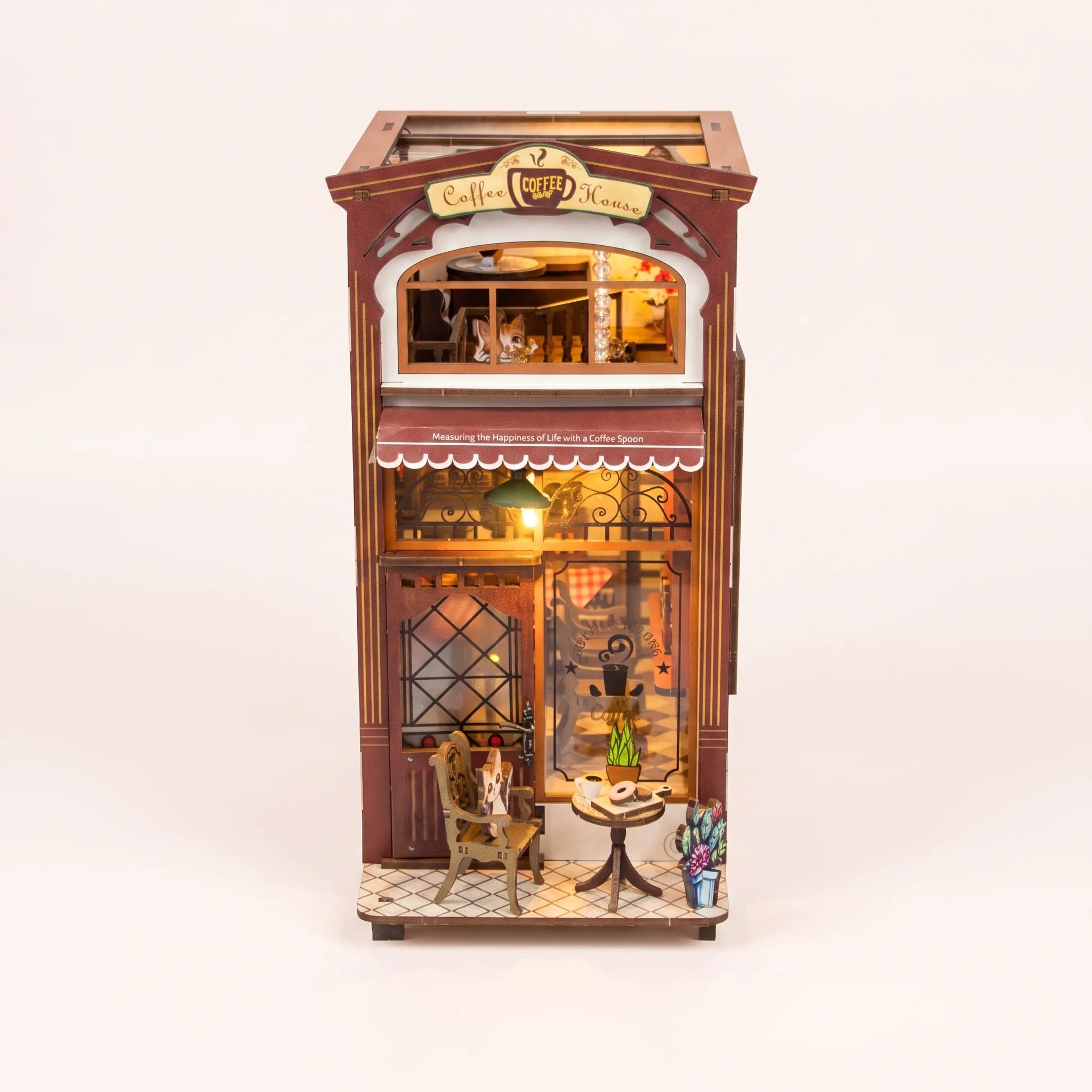 The Coffee House DIY book nook kit with LED lights on a pale blush studio background