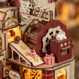 Macro of the cake conveyor, mill wheel and oven with the sleeping kitten