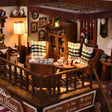 Detail of the upper lounge with plaid armchairs and floor lamp