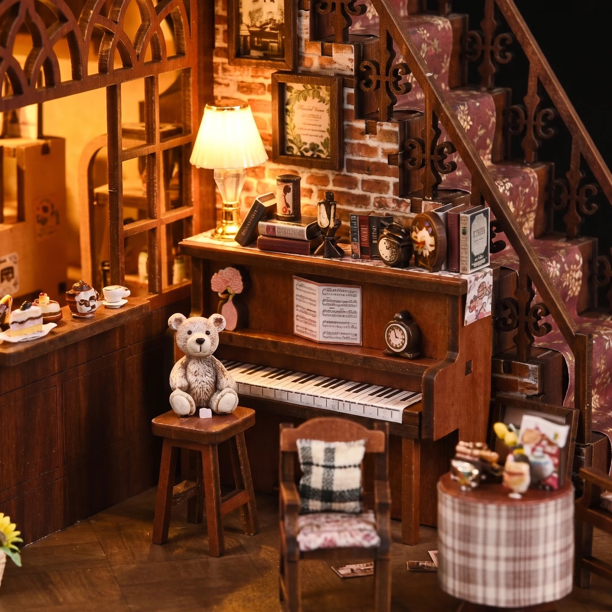 Detail of the teddy bear at the tiny upright piano beside the exterior staircase