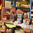 Detail of the tiny dollhouses on the shelves inside The Dollhouse Shop