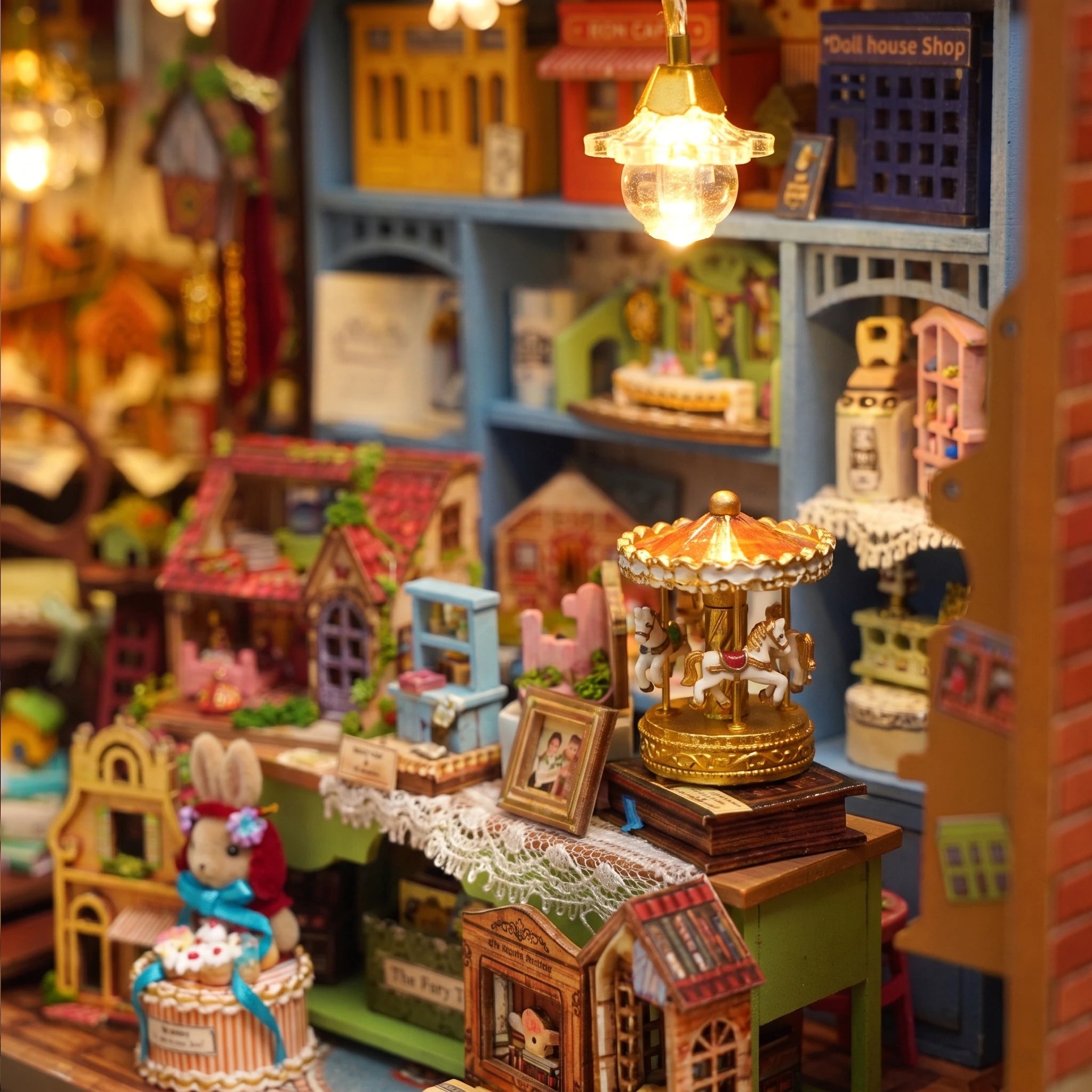 Detail of the gold carousel and rabbit shopkeeper inside The Dollhouse Shop