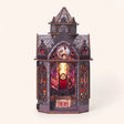The Dragonspire DIY book nook kit, gothic dragon chapel with stained glass dragon window, velvet throne and glowing windows, LED lights on, studio shot on pale blush background
