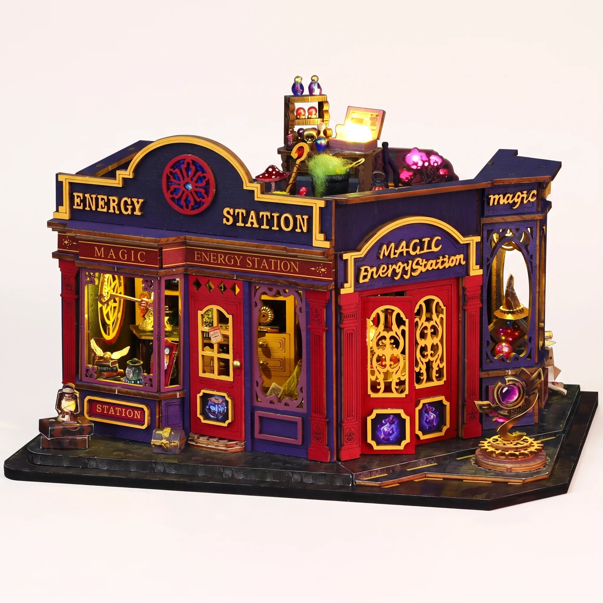 The Elixir Station DIY miniature magic shop kit with LED lights on, on a pale blush background