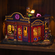 The Elixir Station miniature magic shop glowing on a dark walnut shelf at night