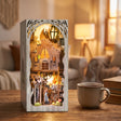 The Emerald Road book nook on a wooden desk beside a mug of tea and books