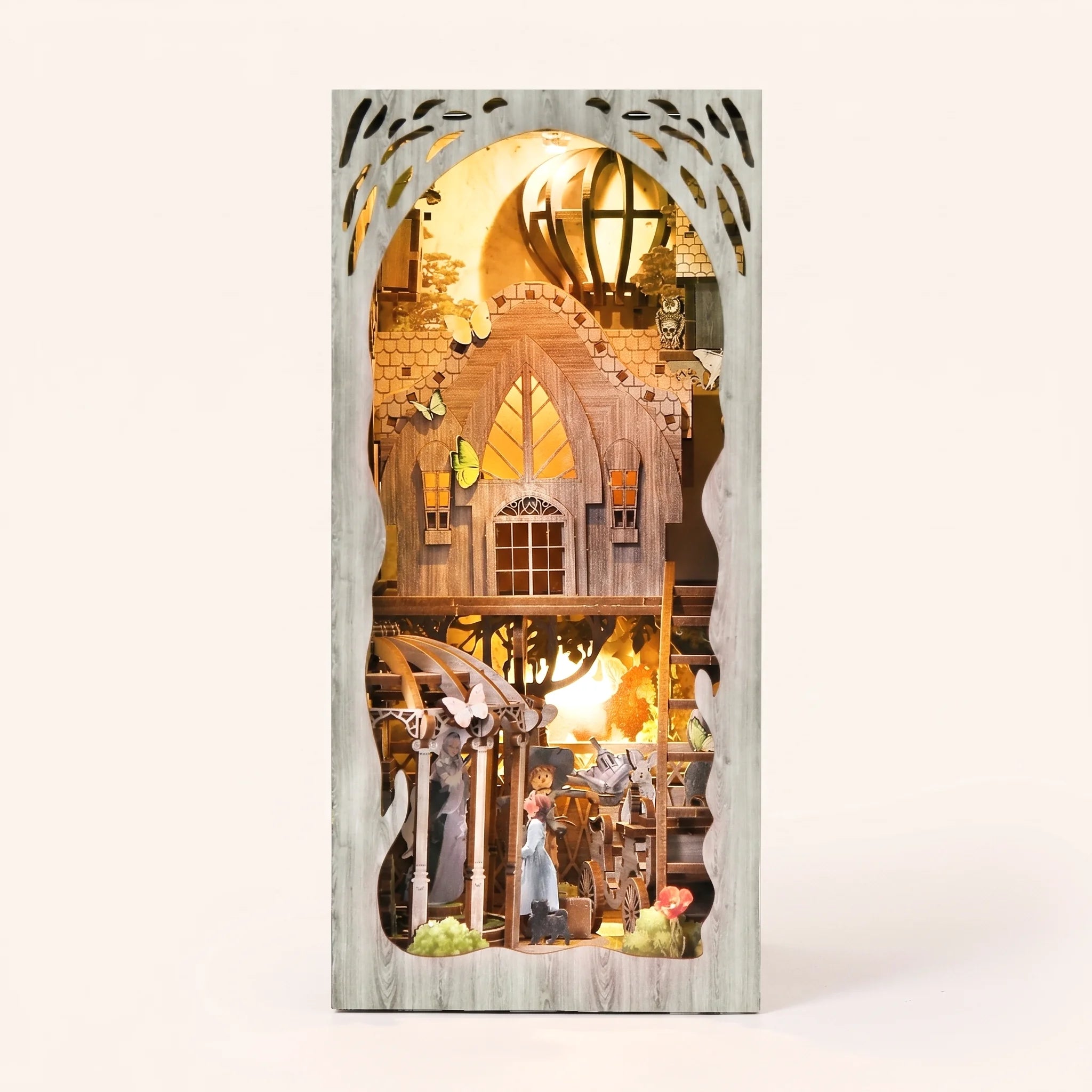 The Emerald Road book nook kit on a pale blush studio background with LED lights on