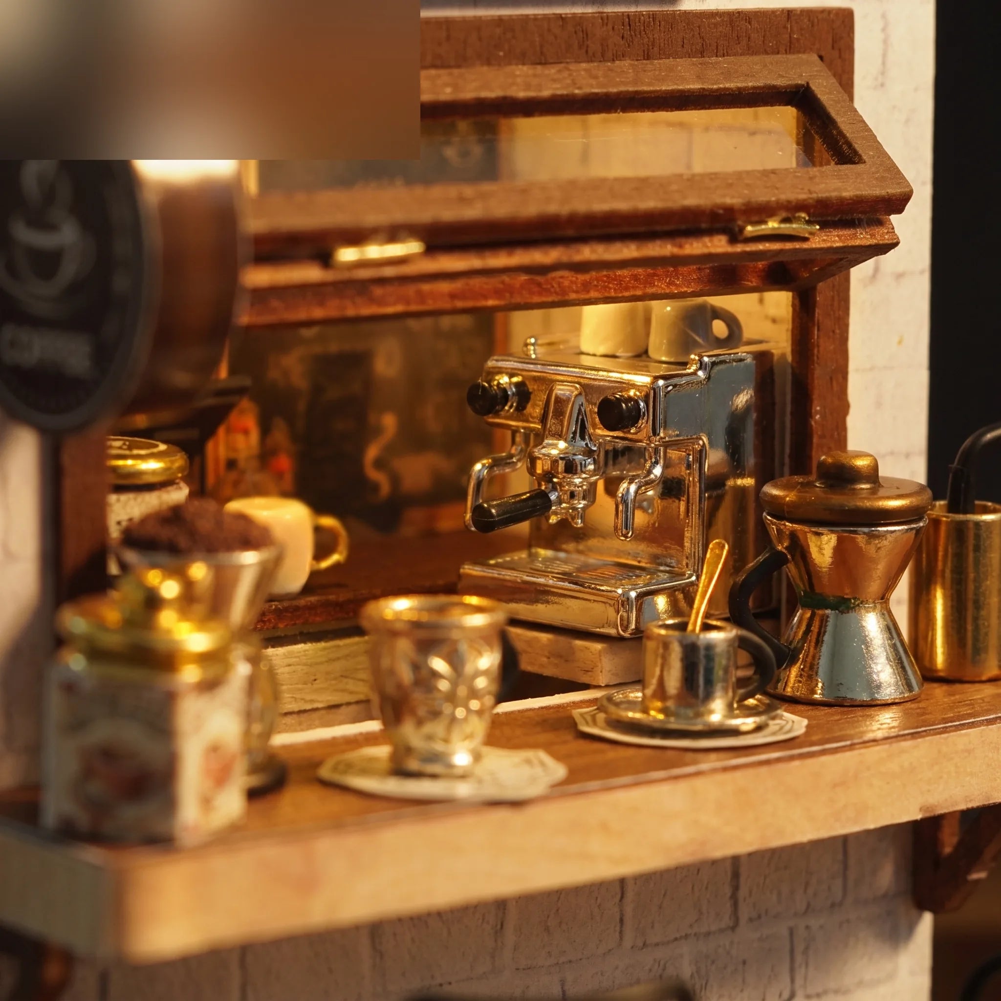 Close-up of the miniature espresso machine and gold pour-over set