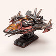 The Explorer One wooden starship kit on its stand, cockpit lit, on a pale blush background