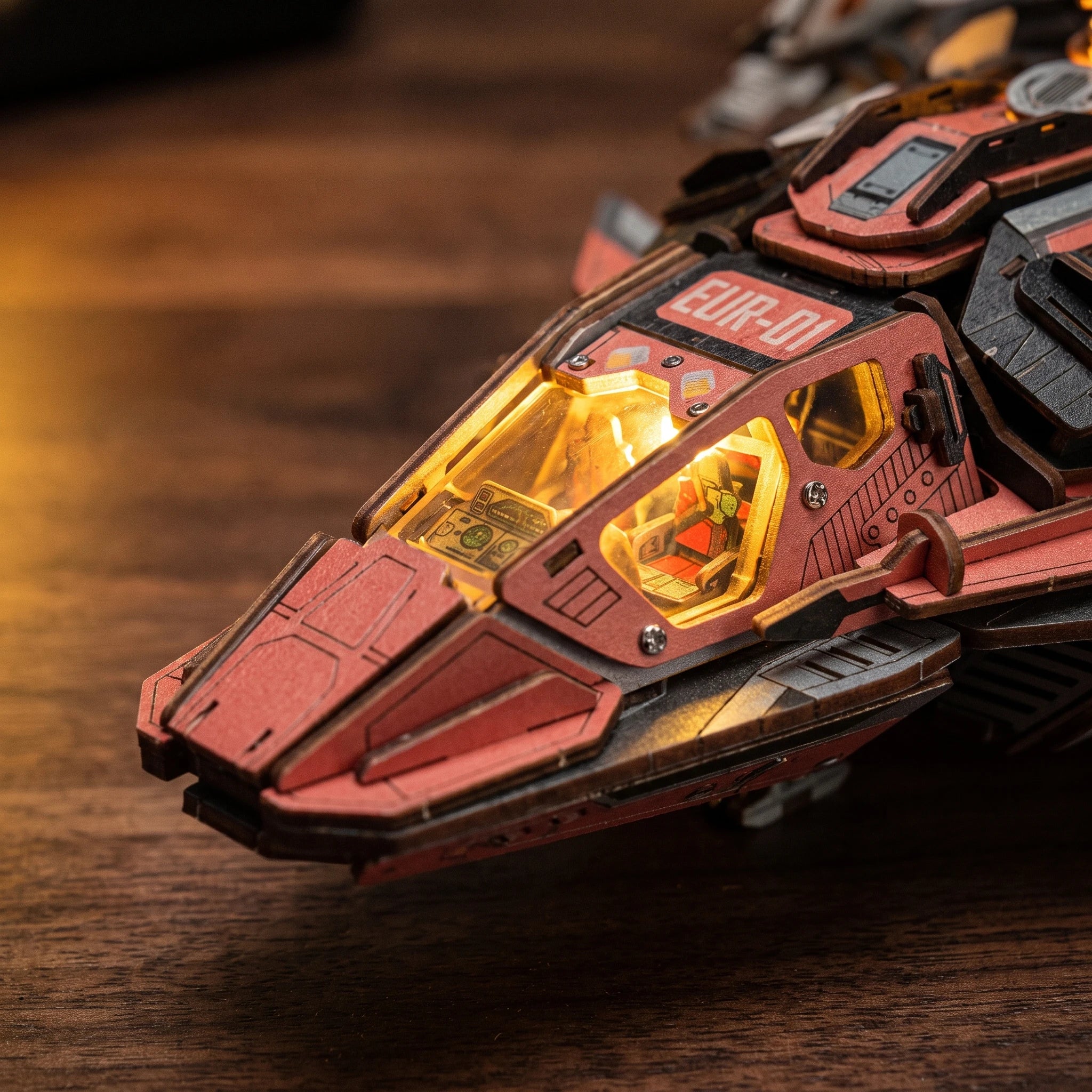 Macro of the amber cockpit canopy with the tiny pilot seat inside