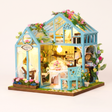 The Floral Reverie miniature greenhouse kit with LED lights on, studio hero shot