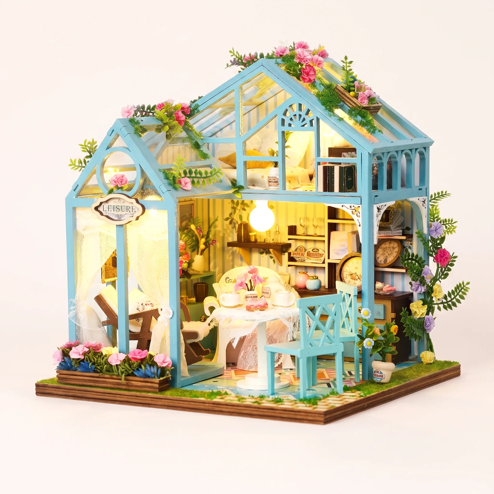 The Floral Reverie miniature greenhouse kit with LED lights on, studio hero shot