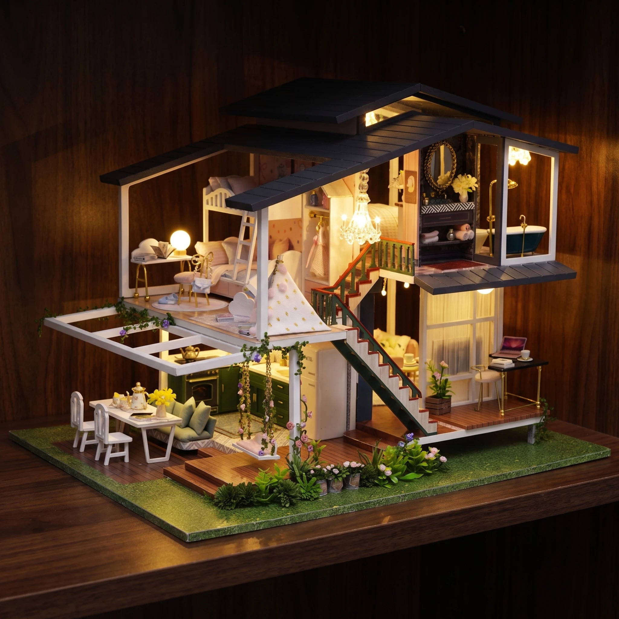 The Giverny Villa glowing at night on a dark walnut shelf