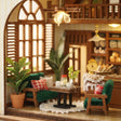 Window nook detail: green armchairs and gingham cushions