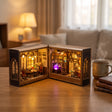 The Grimoire School on a desk at dusk beside a mug of tea