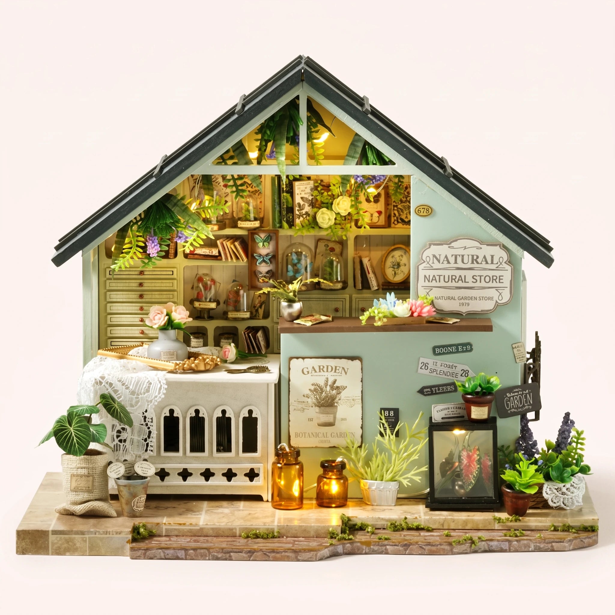 The Herbarium DIY miniature naturalist's garden store kit with LED lights on, front view