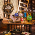 Study desk detail: armillary sphere, spell book and potion vials
