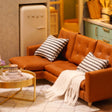 Living room detail: caramel leather sofa and retro fridge