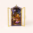 The Midnight Garden DIY book nook kit with gold filigree doors open on a soft cream background