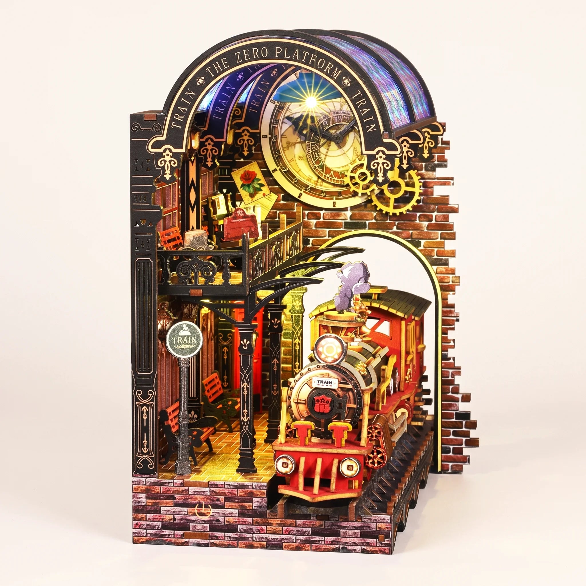The Midnight Platform DIY book nook kit with LED lights on, on a pale blush background