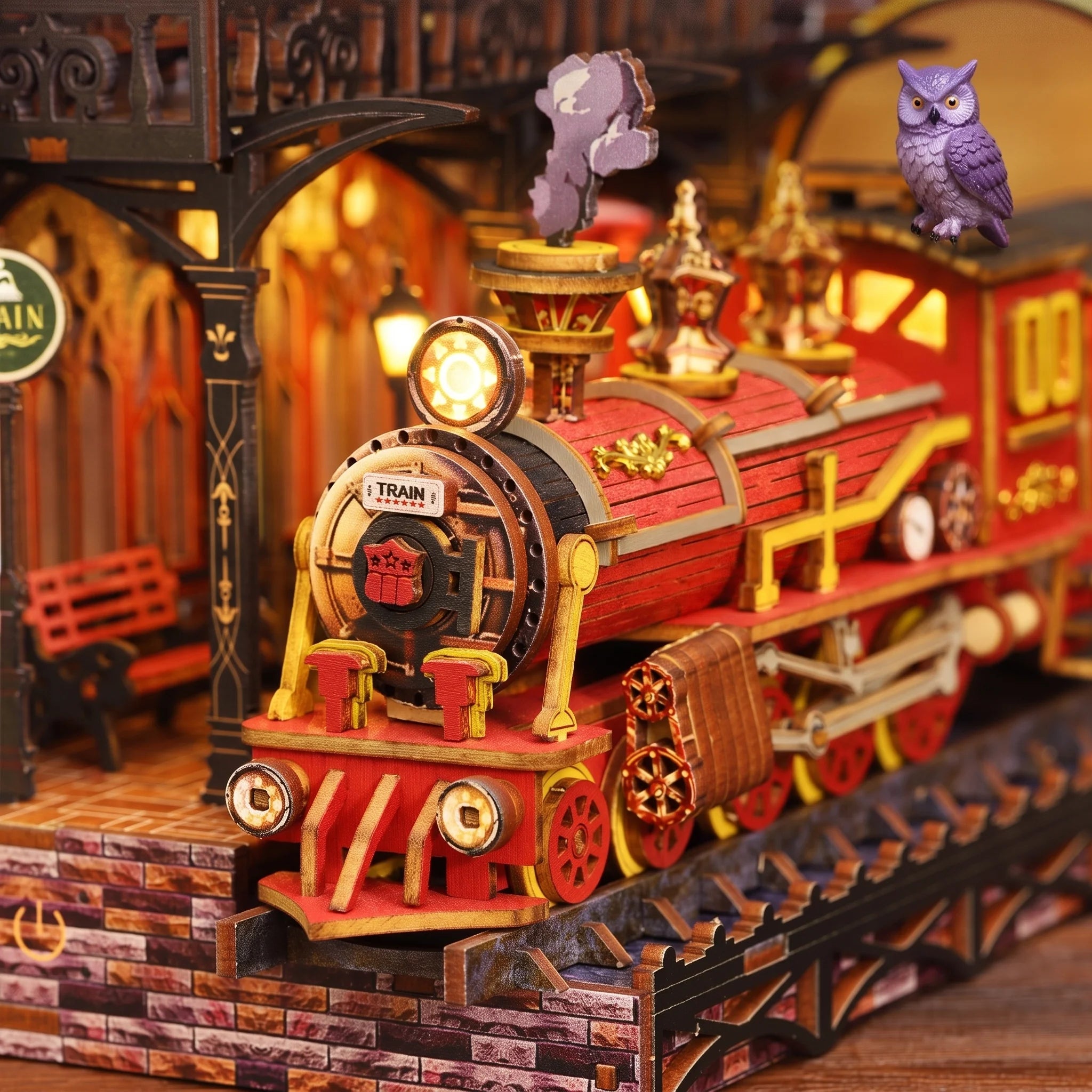 Close up of the red steam locomotive inside The Midnight Platform book nook