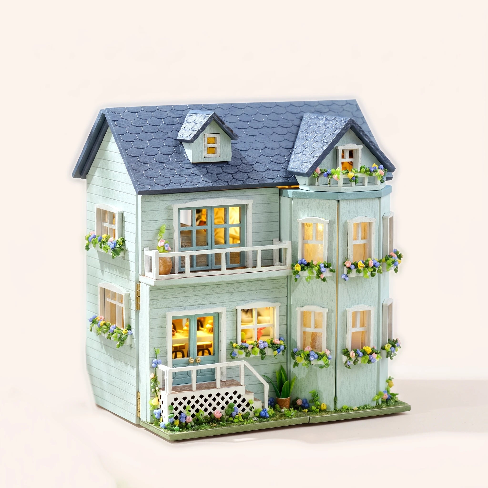 The Mint Gables DIY miniature house kit, assembled with LED lights on