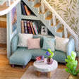 Reading nook detail: blue sofa beneath the staircase