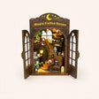 The Moonlit Brew DIY book nook kit, fully assembled with LED lights on