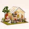 The Morning Greenhouse DIY miniature glass flower shop kit with LED string lights on, front view