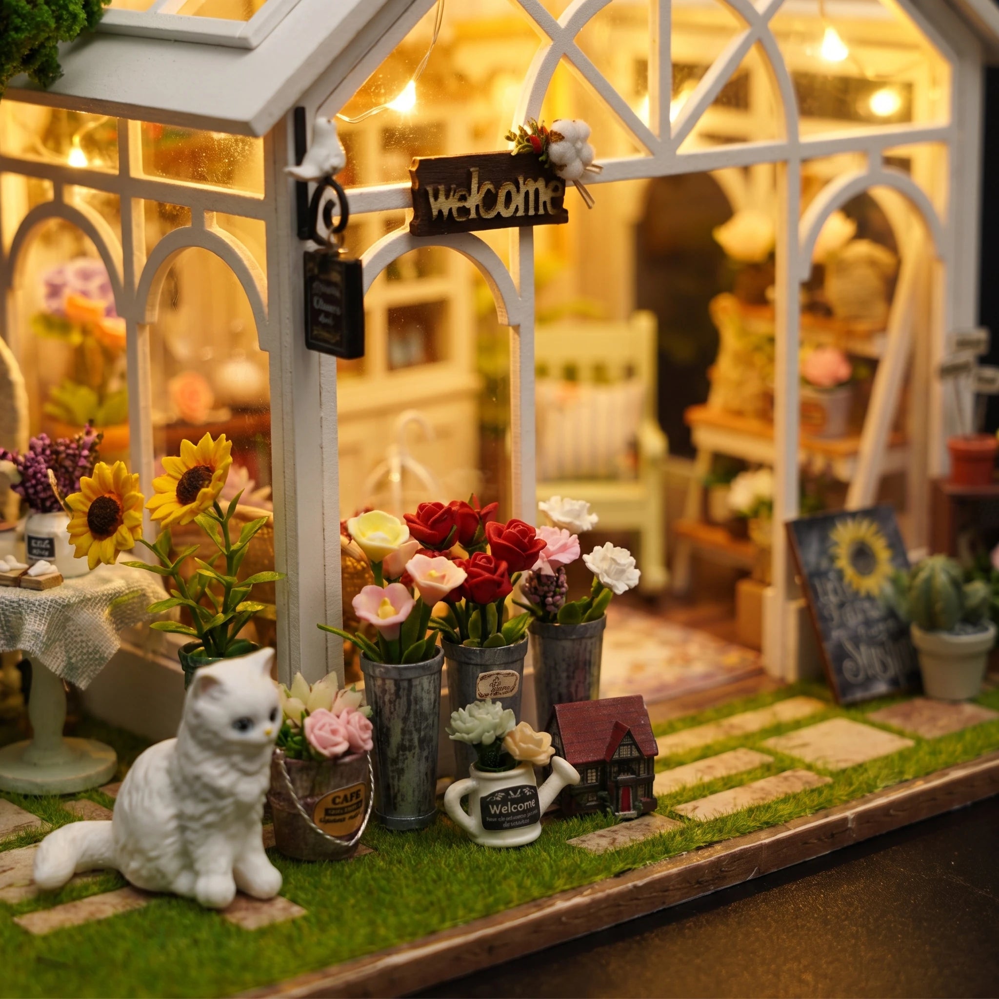Detail of the flower buckets and white cat outside The Morning Greenhouse