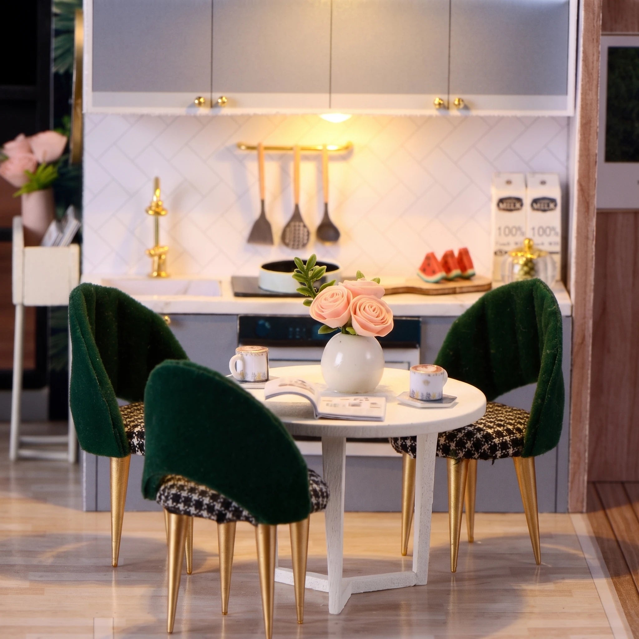 Dining nook detail: green velvet chairs, roses and the slate blue kitchen