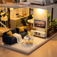 Living room detail: navy sofa, gold coffee table and TV wall