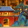Macro of the red palace gate and sculpted pine