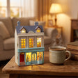 The Paris Boutique lit on a wooden desk beside a mug of tea