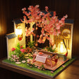 The Petal Courtyard glowing on a walnut shelf at night