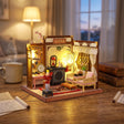 The Poet's Chamber on a desk at dusk beside a mug of tea