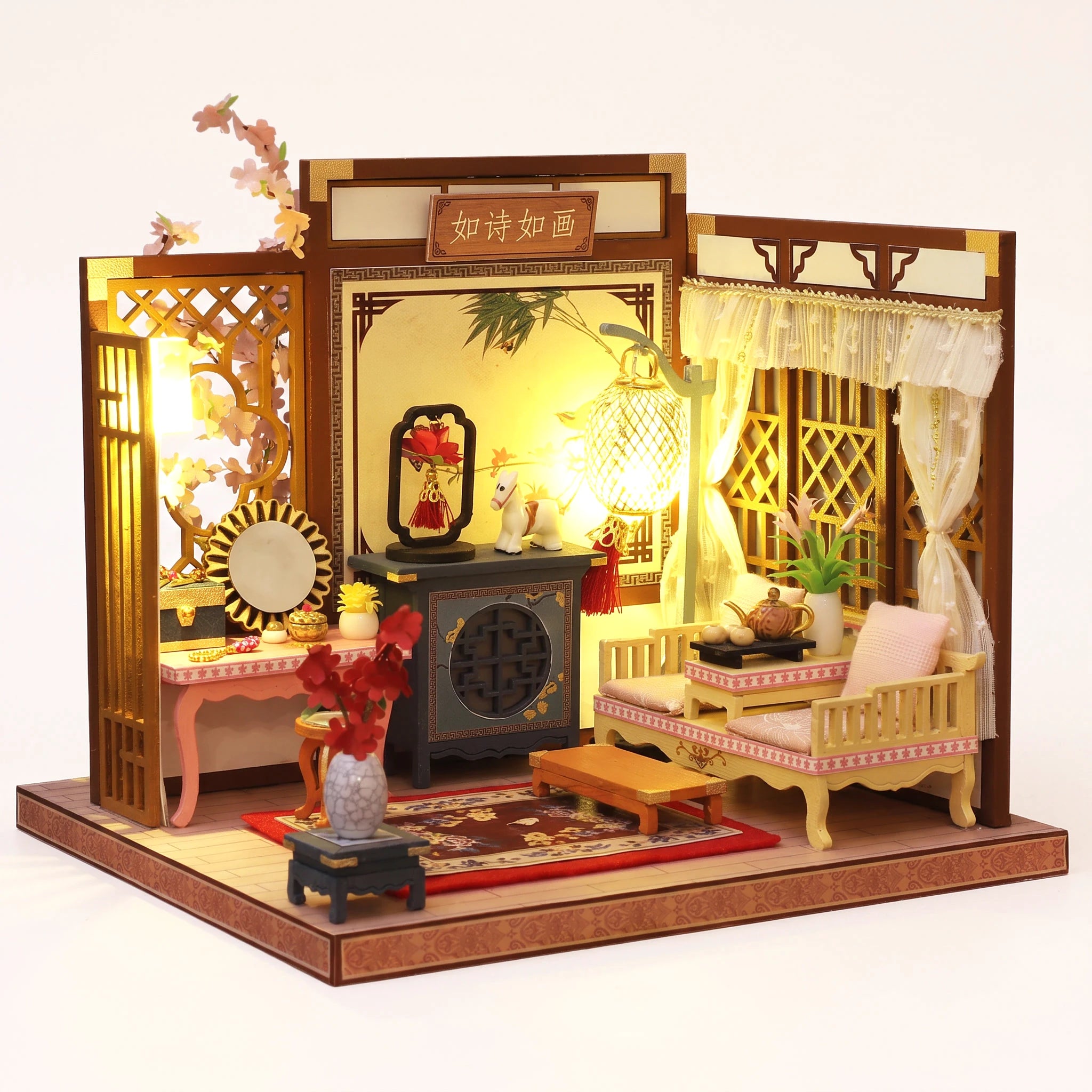 The Poet's Chamber DIY miniature roombox kit, assembled with LED lights on