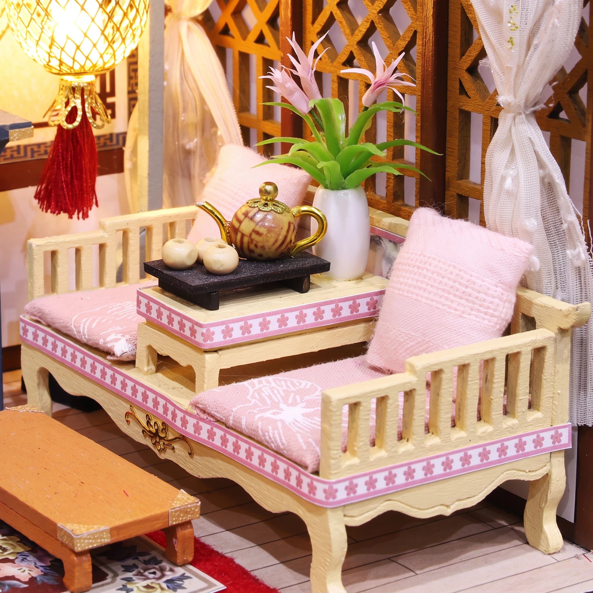 Canopy daybed detail with pink cushions and tea tray