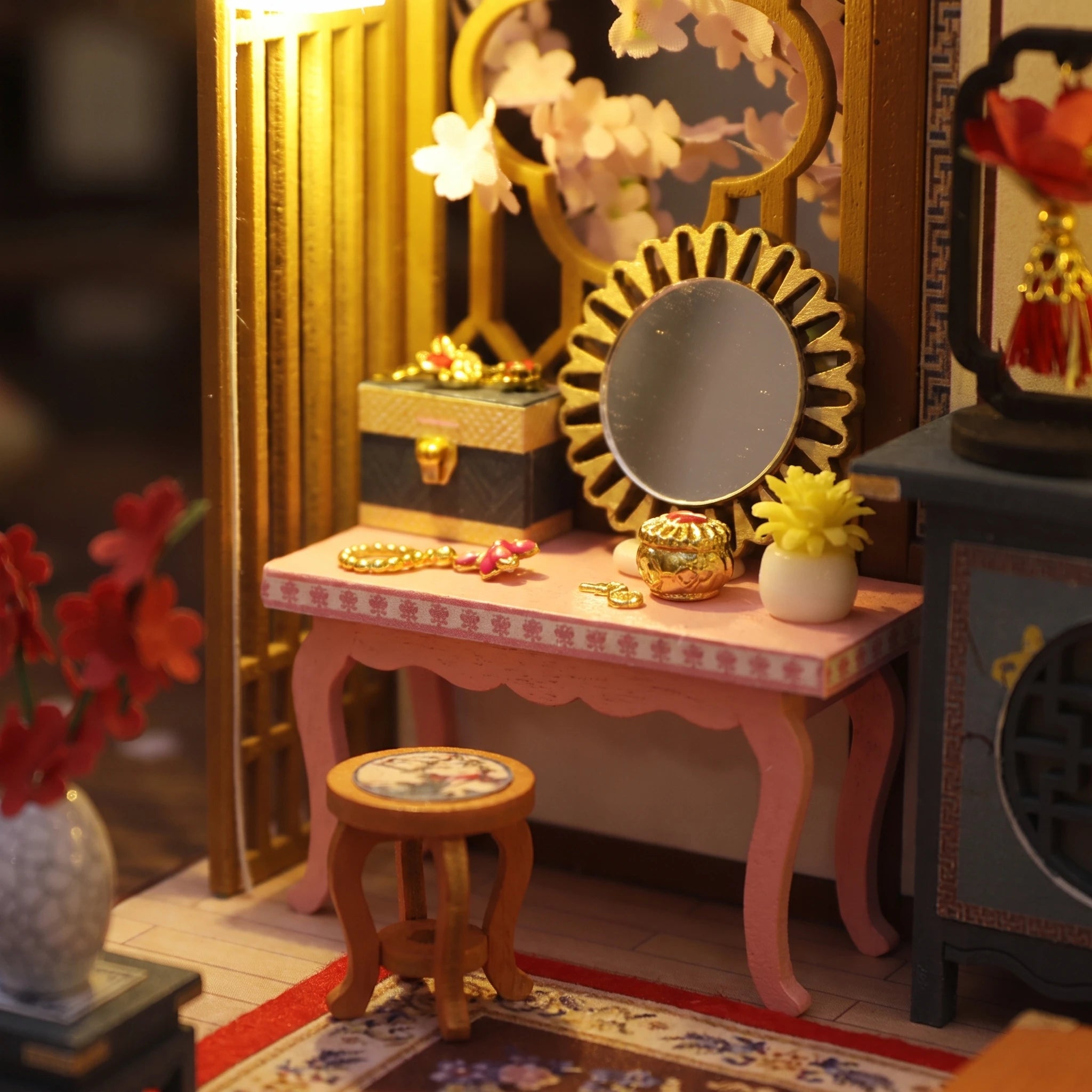 Dressing table detail with round mirror and red blossoms