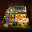The Rose Glasshouse glowing on a walnut shelf at night