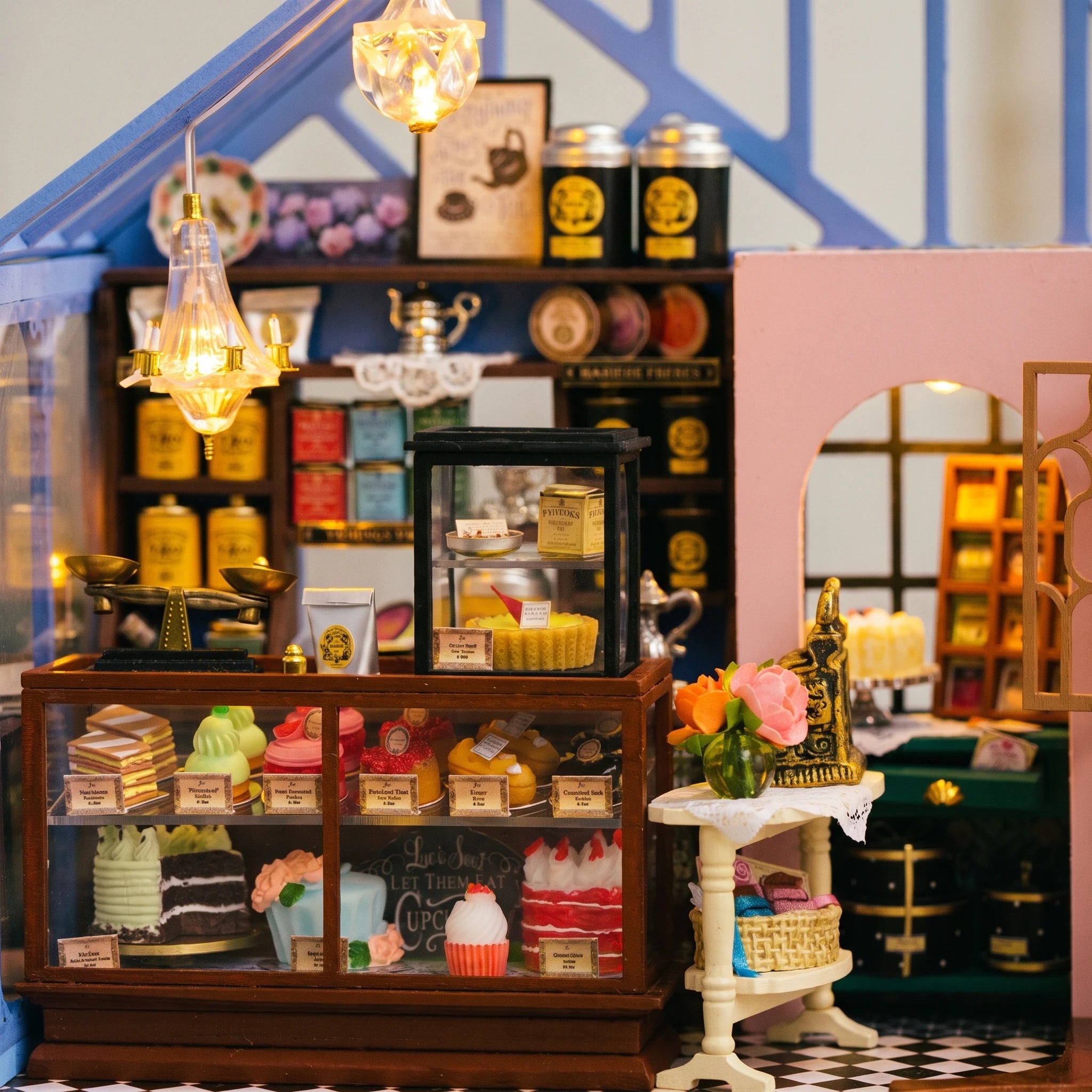 Tea counter detail: tea tins, pastry case and chandelier