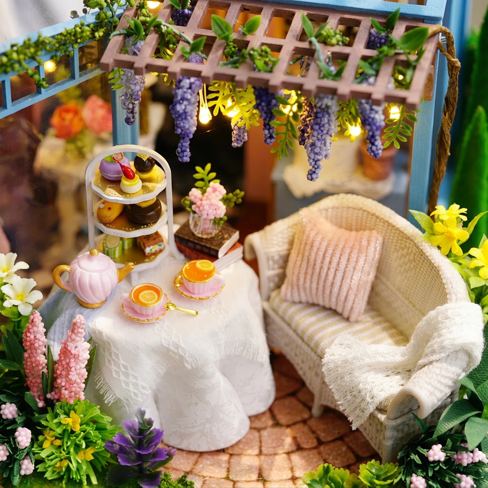 Garden seating detail: wicker sofa, tiered cake stand and wisteria