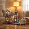 The Storybook Bazaar lit on a desk at dusk beside tea and books