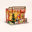 The Sugarplum Shop DIY Christmas miniature kit with LED lights on a pale blush background
